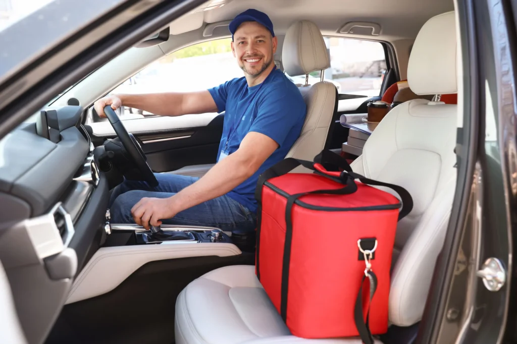 Fast food delivery driver with his bag on the passenger seat