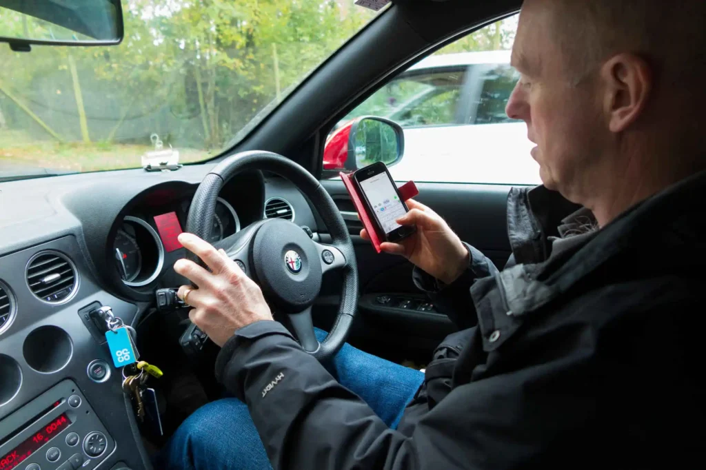 Man texting on his phone while driving