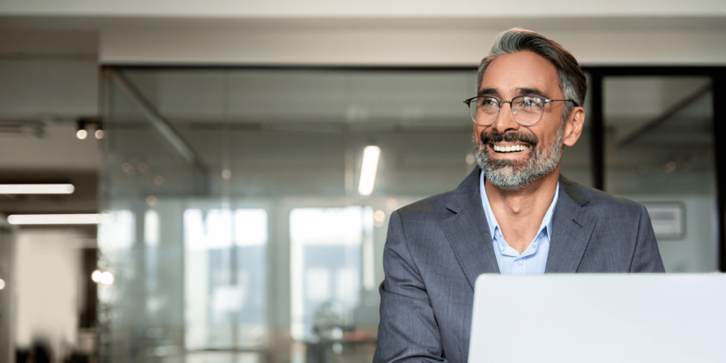 Confident male director in a modern office setting, representing the importance of directors and officers insurance for leadership roles.